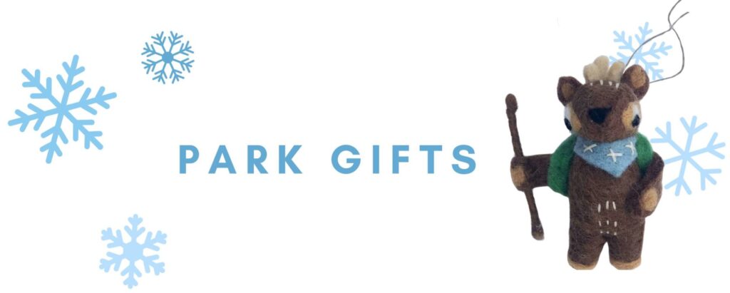 A graphic that includes a photo of a felted ornament in the shape of a deer with a backpack and hiking stick, several graphic snowflakes, and the words park gifts.