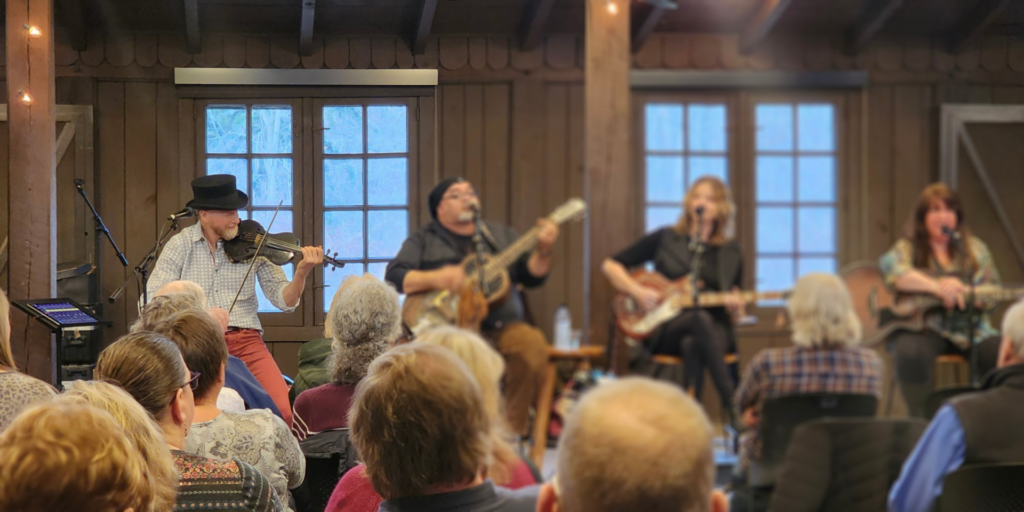 Ed Caner and friends performing before a crowd