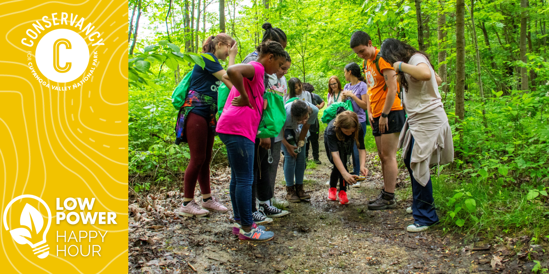 Group of students looking at something on the ground.